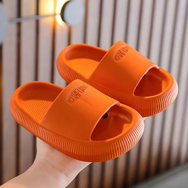 Children's mixed colour EVA slippers with textured sole, shown in blue, green, orange, pink, and yellow.