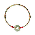 Colourful braided rope bracelet with peace buckle closure showing woven texture