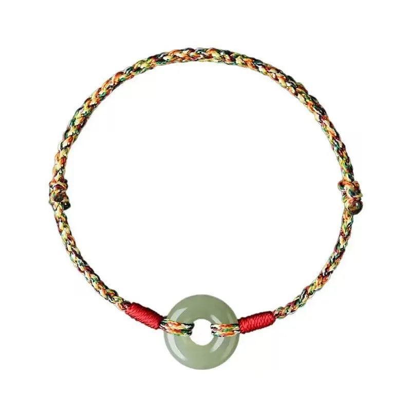 Colourful braided rope bracelet with peace buckle closure showing woven texture