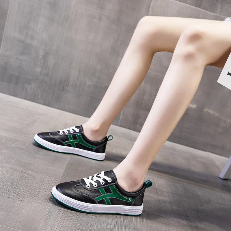 Women's white and black leather sneakers with elastic band closure and round toe