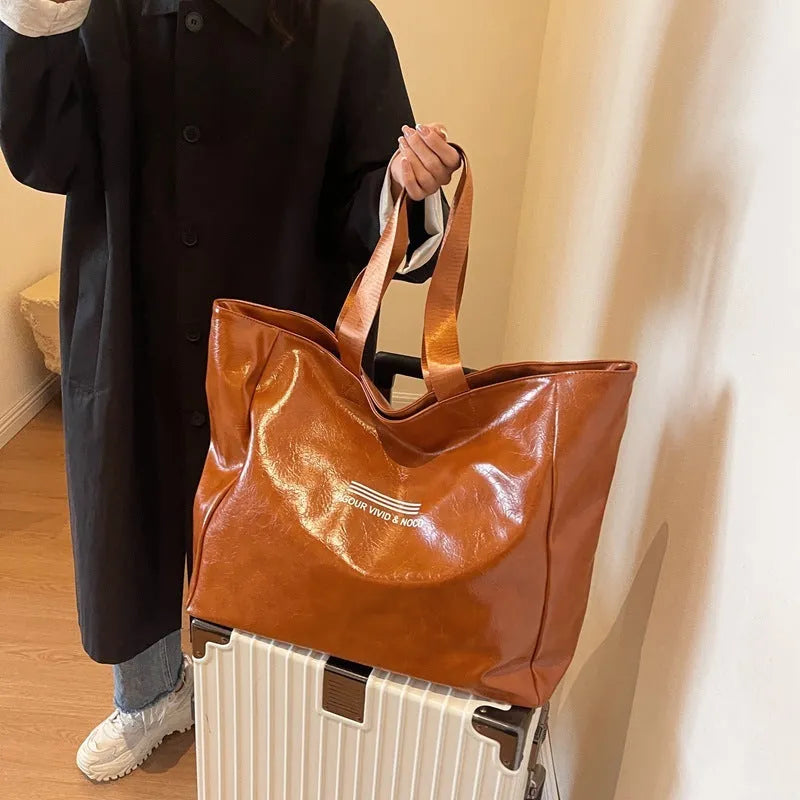 Large capacity PU tote bag for women in solid black, beige or brown, waterproof shoulder handbag for daily and travel use.