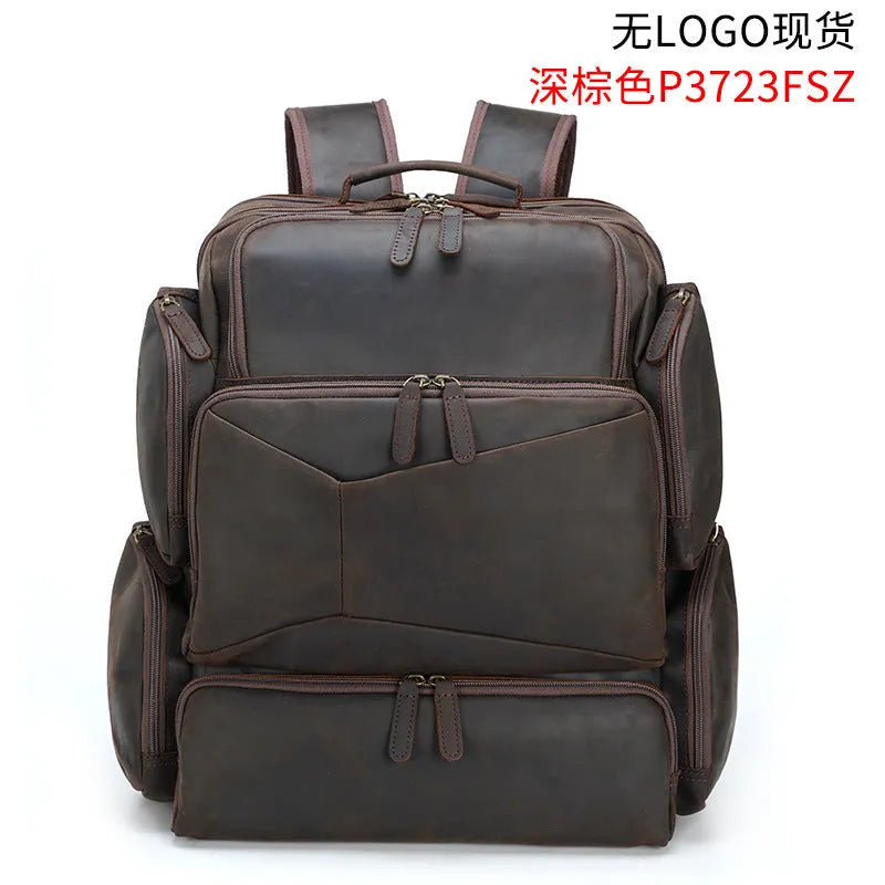 Dark brown men's leather backpack open to show internal compartments for a 17-inch laptop and organisation pockets.