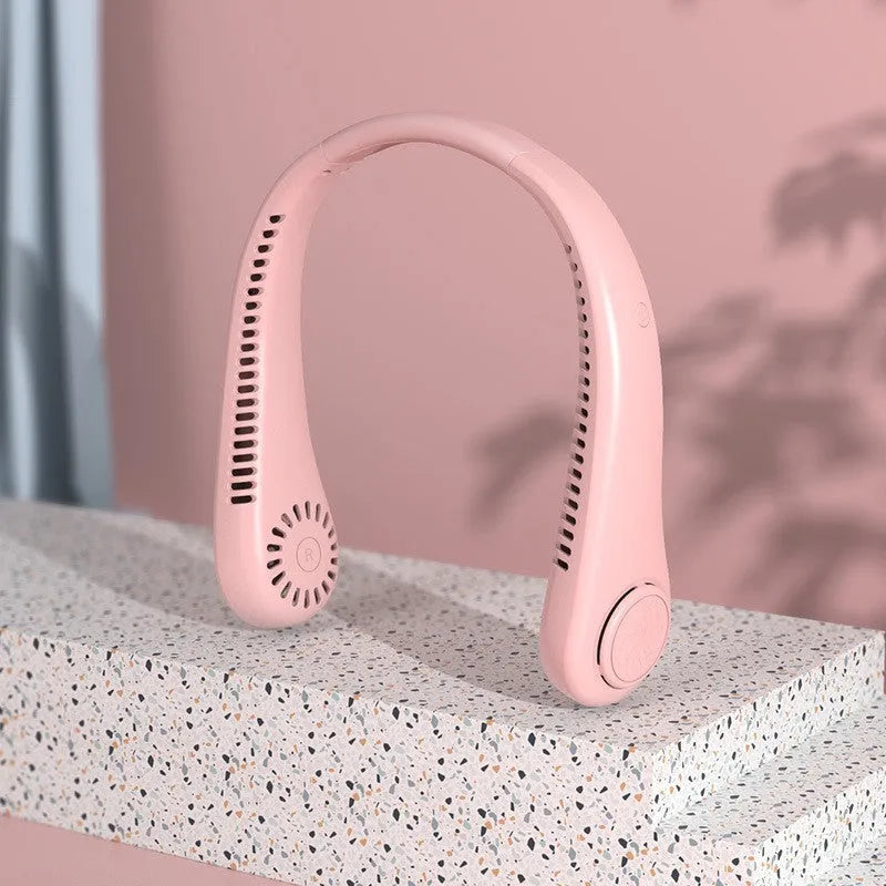 Blue portable bladeless neck fan hanging around a person's neck, showing the USB port.