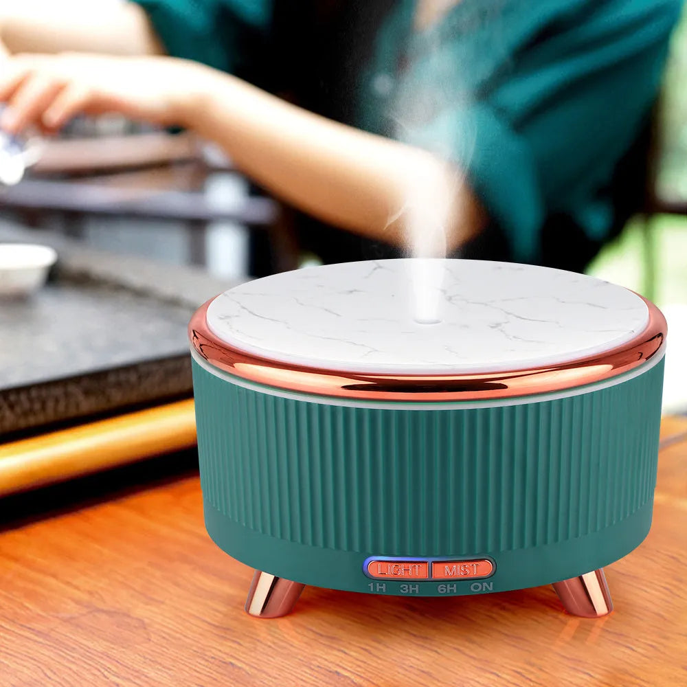 Round wood grain ultrasonic aroma diffuser with 500ml tank, five colour options, on a desktop