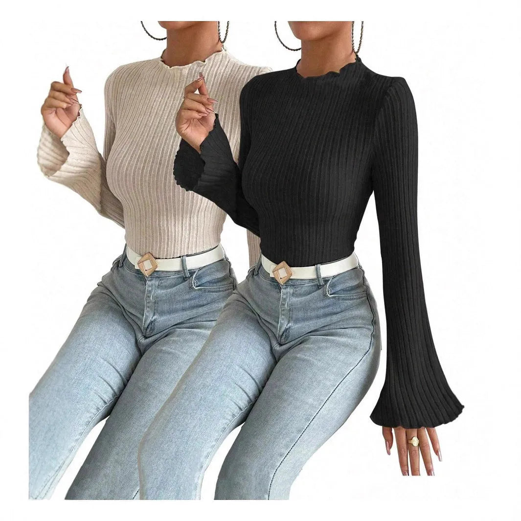 Long sleeve casual top in black with lantern sleeves and a sunken stripe pattern, laid flat.