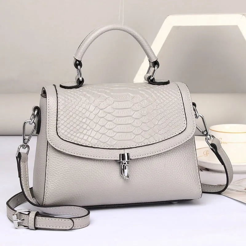 Real leather cross-body bag in head layer cowhide with crocodile print, small square shape, lock opening, blue or brown.