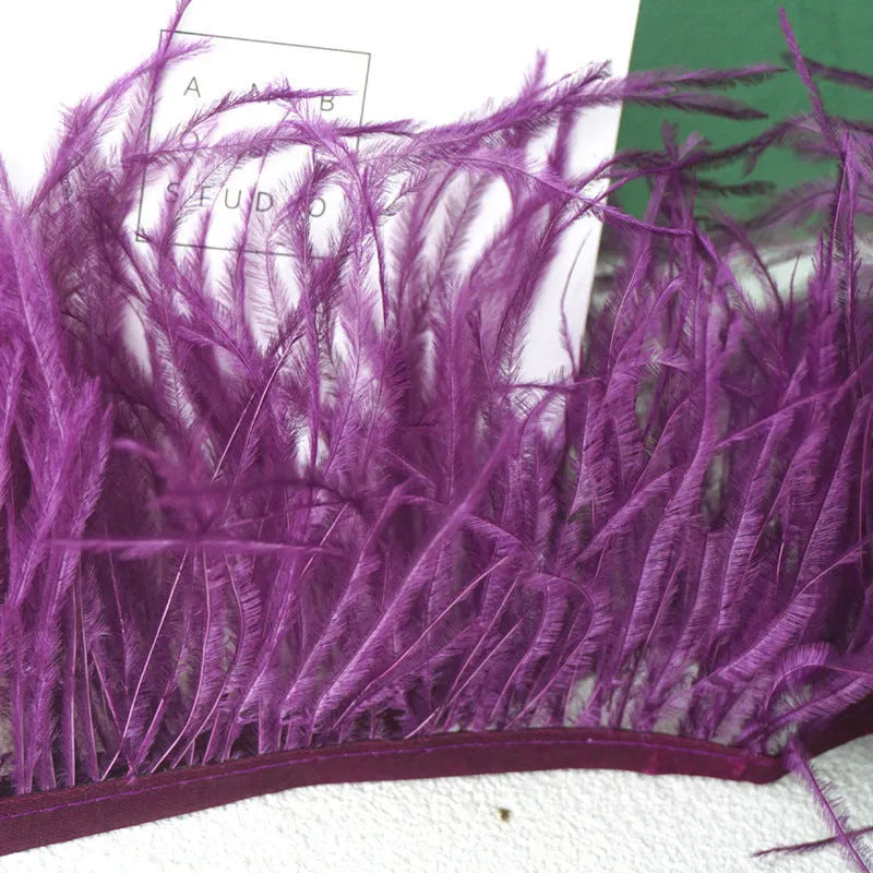 Decorative feather cloth strip in multiple colours including white, black, and mint green for DIY clothing and craft projects