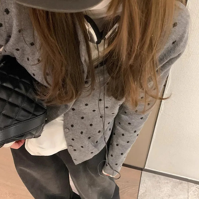 Women's grey dot pattern knitted cardigan with crocheted flower details on front