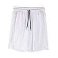 Man wearing black loose-fit quick-dry mesh capri shorts for casual summer fitness.