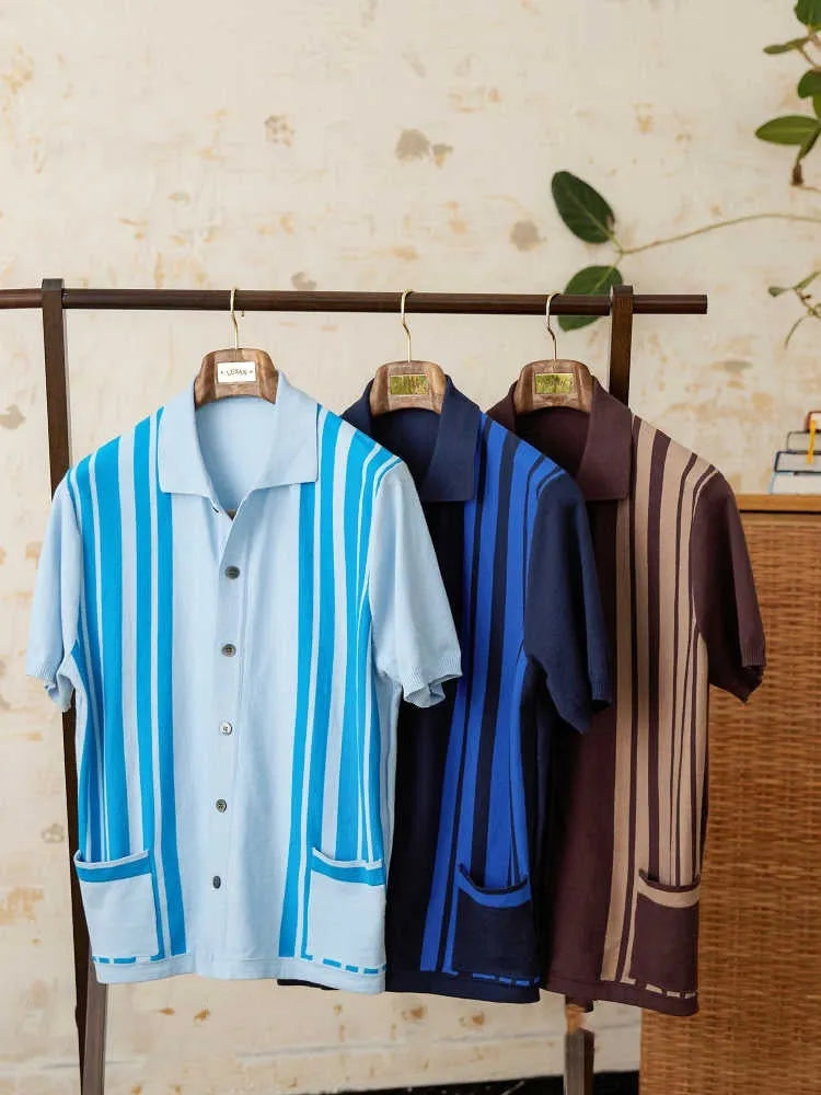 Light blue striped cotton polo cardigan with short sleeves and a lapel collar on a hanger.