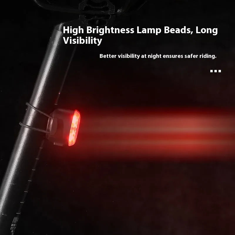 Round red bike warning light mounted on bicycle handlebar with silicone strap for night riding safety