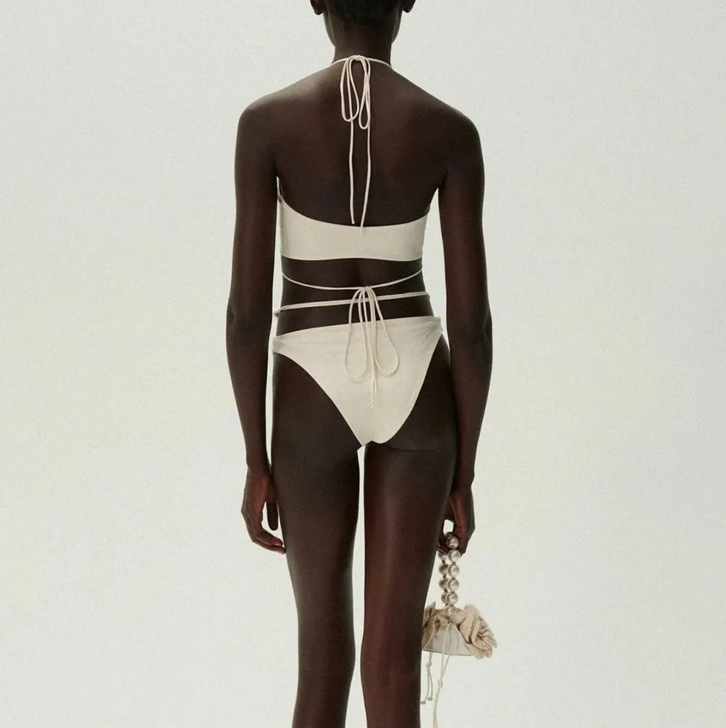 Black women's lace-up bikini swimsuit with separate bra and shorts pieces on mannequin