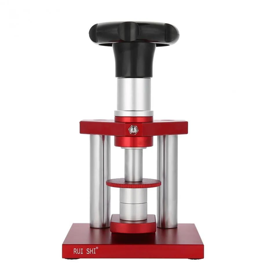 Watch back cover press tool, a spiral cap presser machine, shown with a set of 20 plastic moulds for different watch sizes.