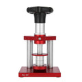 Watch back cover press tool, a spiral cap presser machine, shown with a set of 20 plastic moulds for different watch sizes.