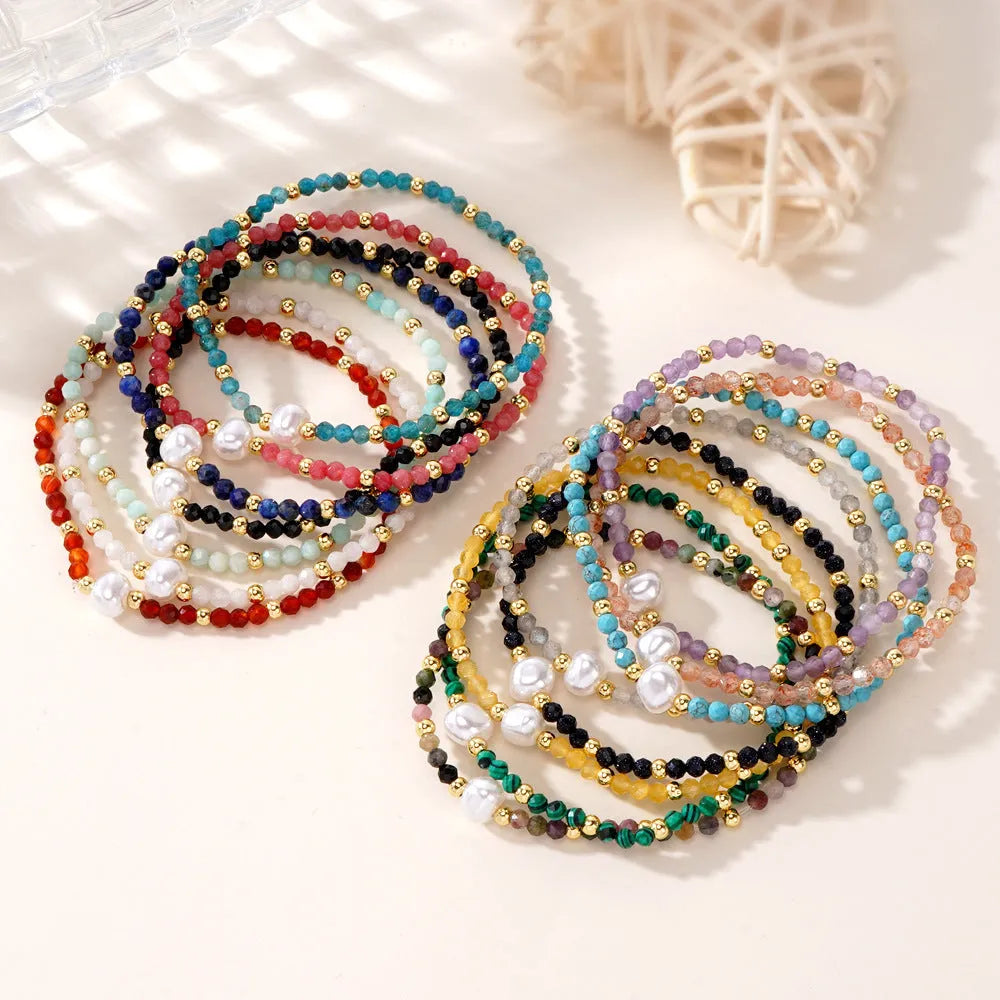 A unisex natural stone bracelet with elliptical geometric beads on a wrist, shown in one of the multiple available colours.