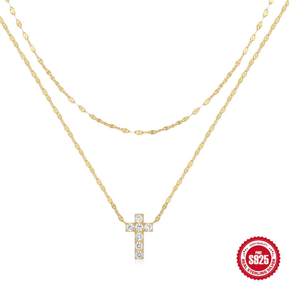 Close-up of a sterling silver double layer twin diamond cross pendant necklace on an adjustable chain.
