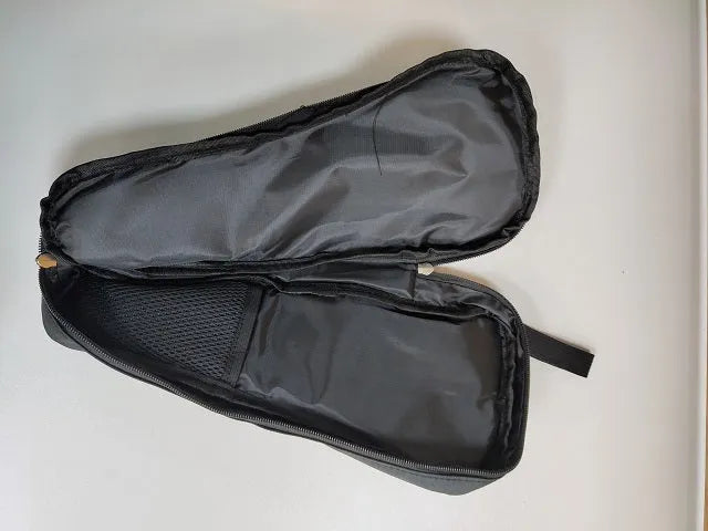 Black cloth zippered storage pouch for a mobile phone gimbal and its accessories on a table