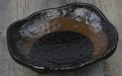 Japanese-style irregular coarse pottery sashimi bowl with floral decoration on glaze
