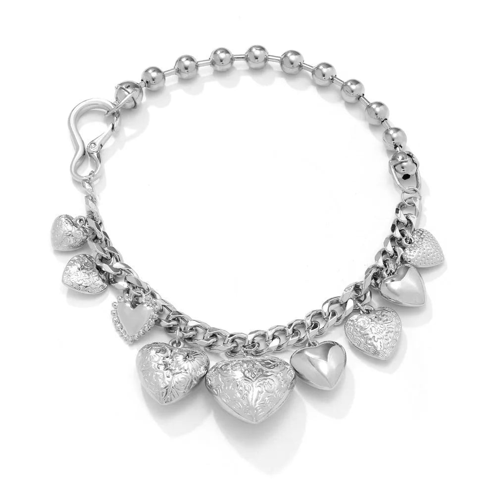 Gold women's necklace with a large, exaggerated heart-shaped pendant on an adjustable chain.