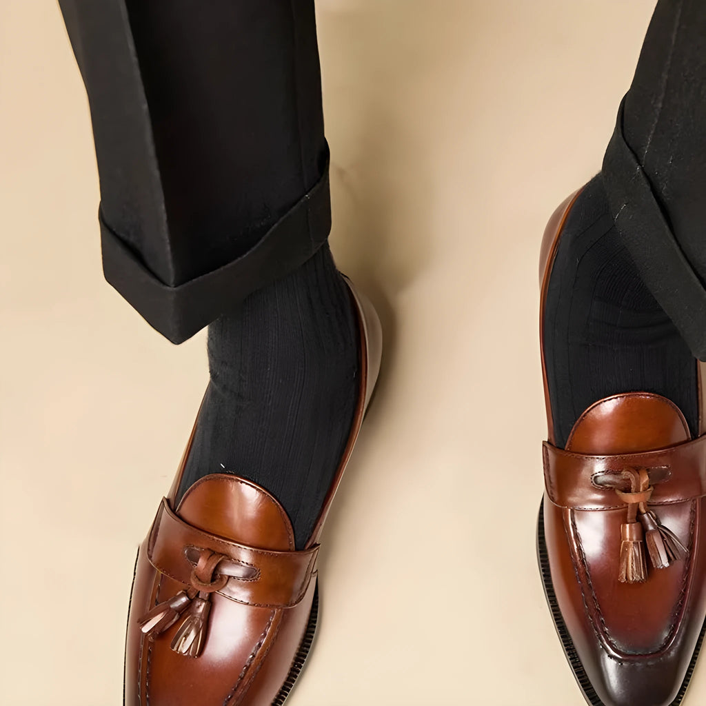 Men's polished leather tassel loafers in black and brown with pigskin lining and rubber sole