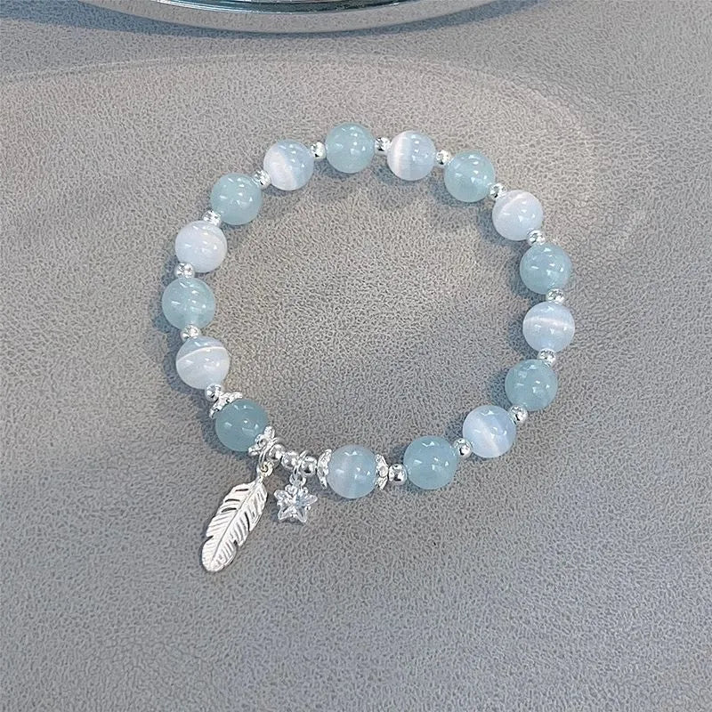 Korean style glass and coloured glaze crystal bracelet in feather XINGX blue moonlight colour with text detailing