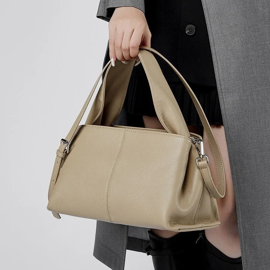 Women's genuine cowhide messenger bag with retro texture in horizontal square design showing shoulder straps and exterior pocket
