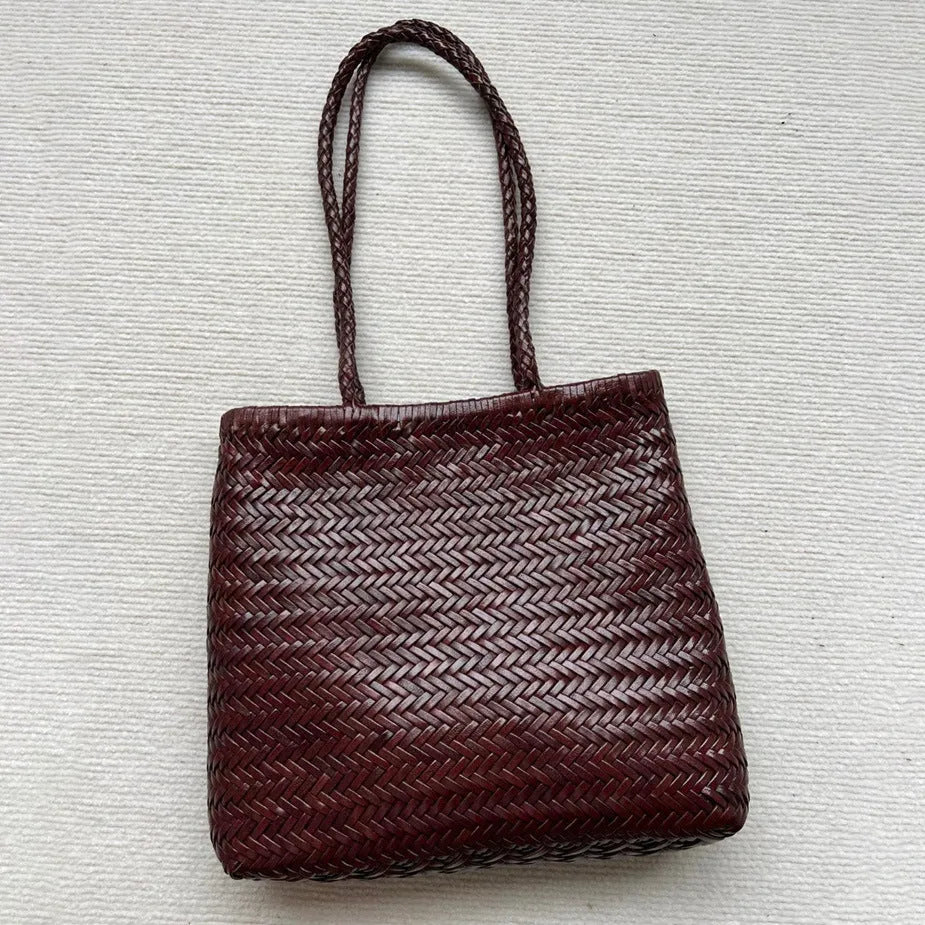 Brown handmade woven cowhide leather tote bag with a three-dimensional outer pocket.
