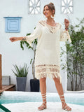 Apricot hand-crocheted women's beach dress on a hanger.