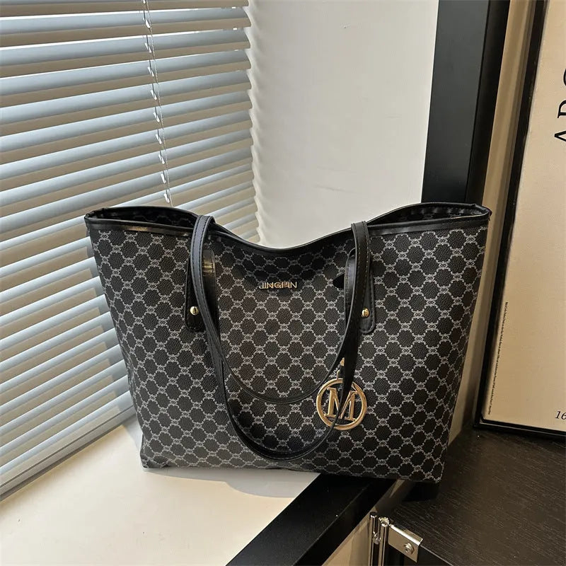 PU leather shoulder bag with adjustable strap in black, shown with visible stitching detail.