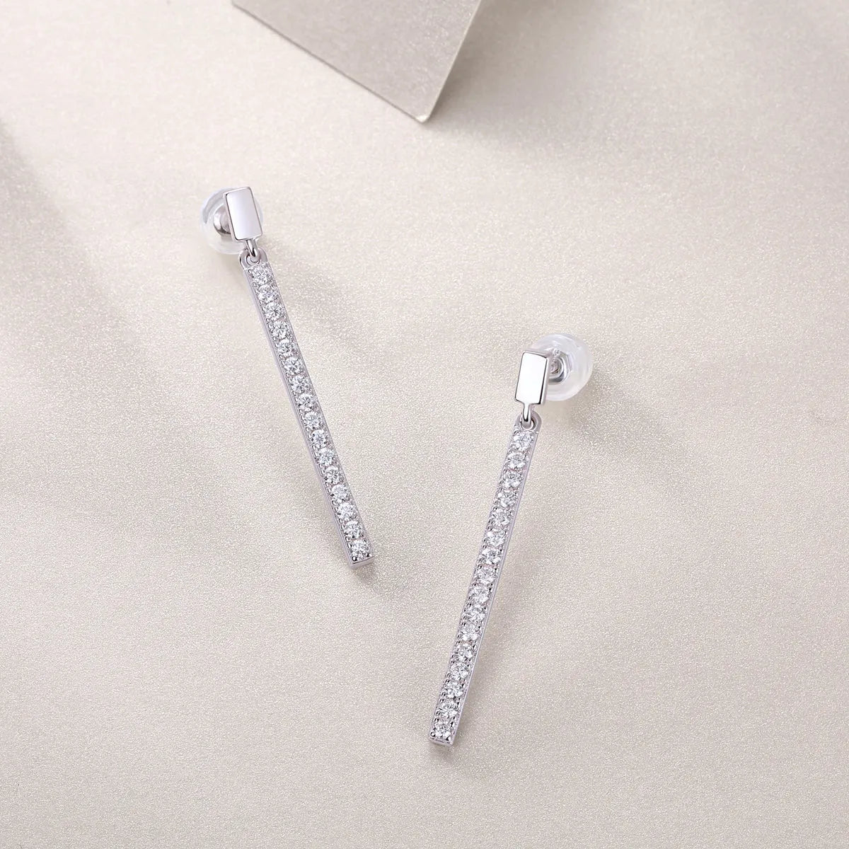 Pair of moissanite stud earrings in S925 silver with platinum plating on white background