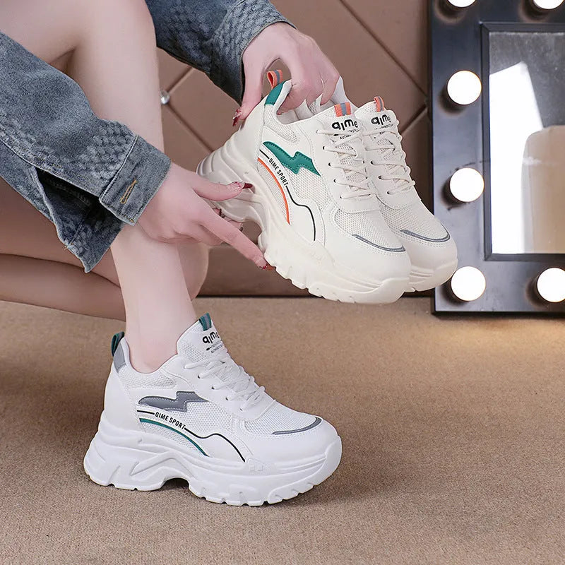 Women's white breathable dad shoes with cross strap and lace-up front on a rubber sole.