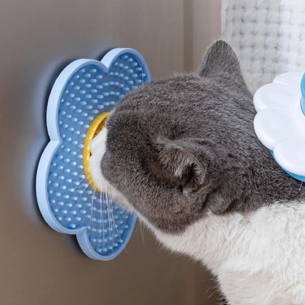 Flower-shaped silicone pet lick mat with suction cups on a smooth surface in assorted colours.