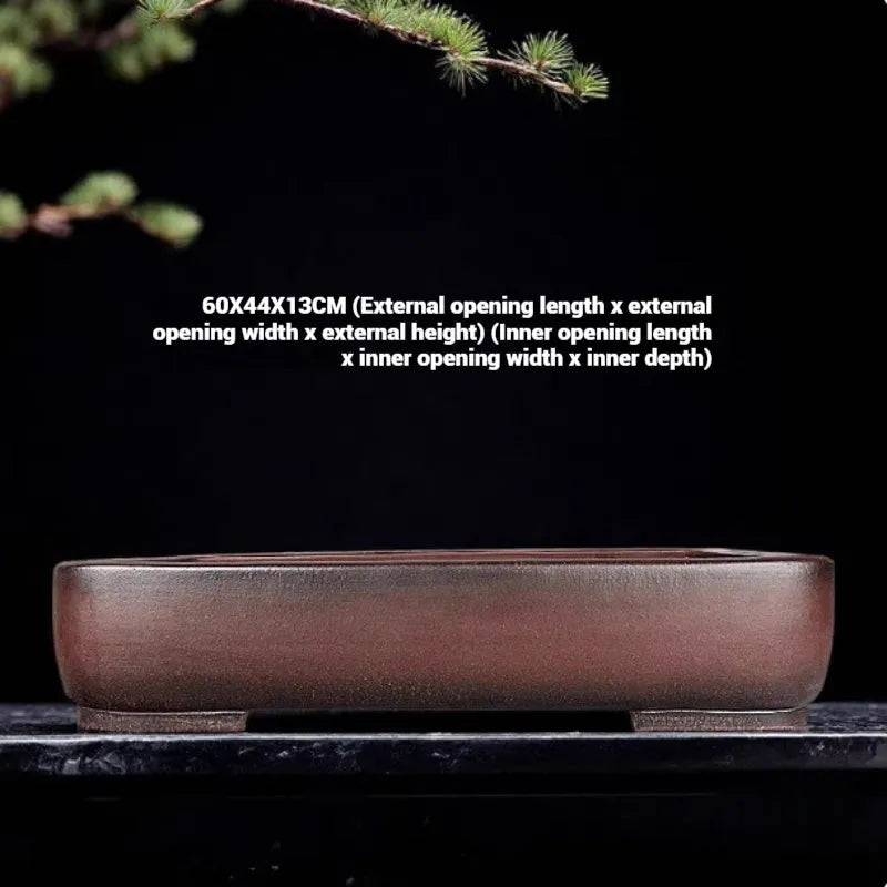Handmade large rectangular purple clay flower pot for floor plants on a table.