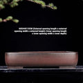 Handmade large rectangular purple clay flower pot for floor plants on a table.