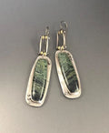 Geometric alloy earrings with a two-colour marble pattern on a white background.