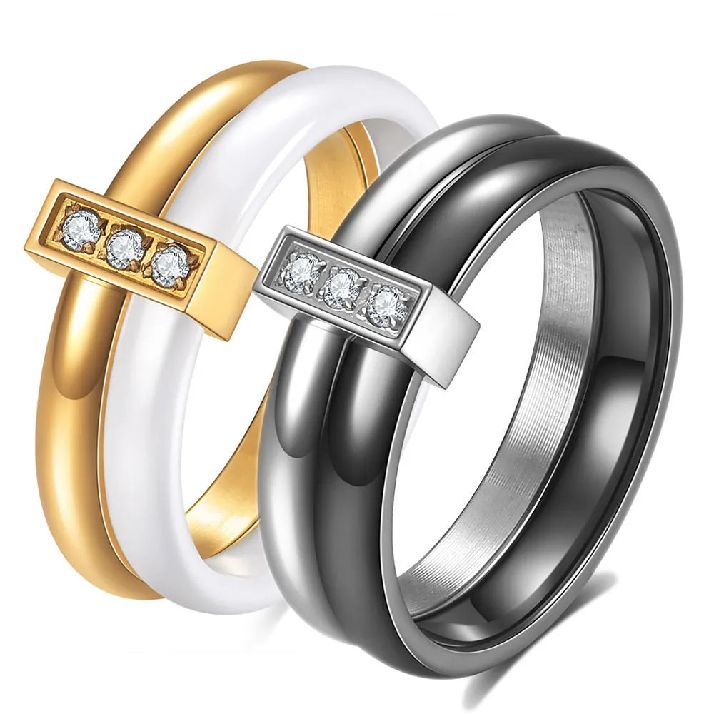 Glossy black geometric ceramic ring with a 6mm wide band on a woman's finger.