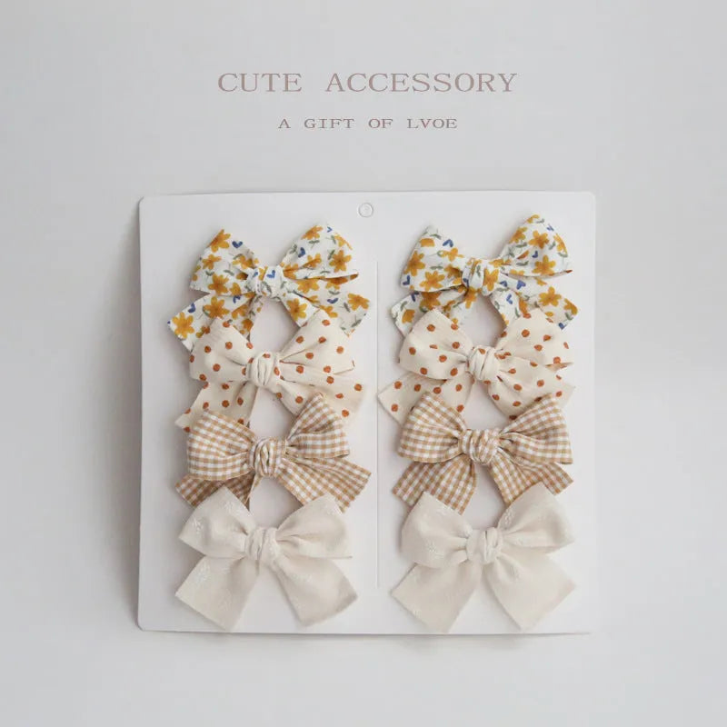 Dovetail bow hairclip set for children in cloth material with eight colour options