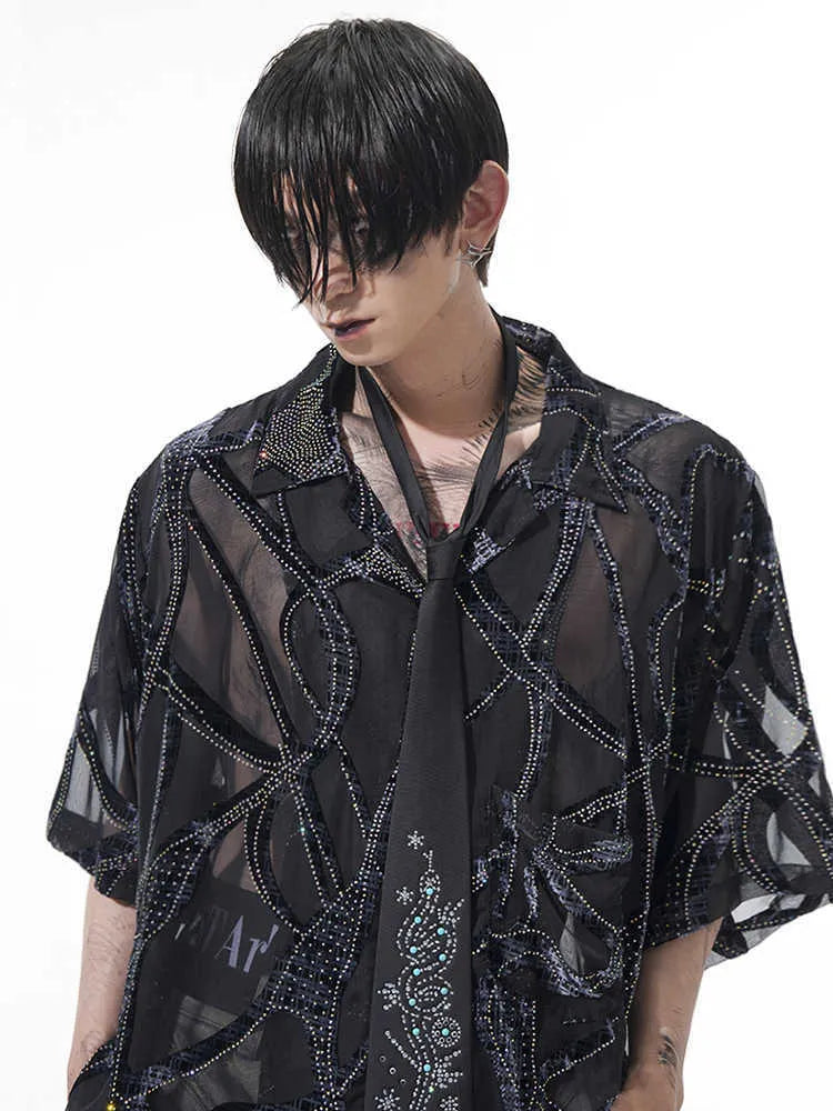 Man modelling a black and grey snake pattern translucent short-sleeved loose-fit shirt