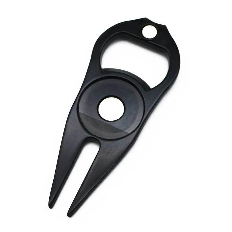 Zinc alloy golf multi-tool with ball yoke, bottle opener, and fork end on a green background.