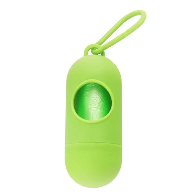 Black dog waste bag holder with Velcro strap and metal hook, showing bag dispenser slot.