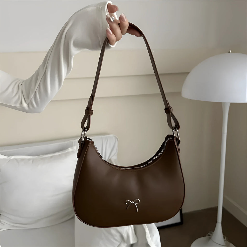 Women's underarm small shoulder bag in dumpling shape, shown in one of six colours: white, black, pink, khaki, brown, or silver.