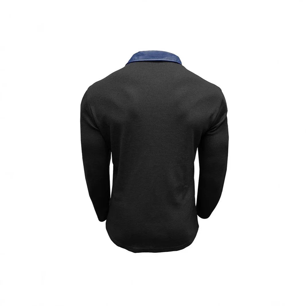 Man wearing a long-sleeved waffle-knit polo shirt in a solid colour with a loose, asymmetric retro fit.