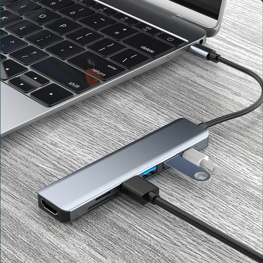 Seven-in-one Type-C USB expander hub with a short cable on a desk