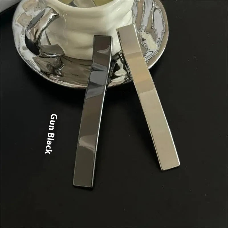 Metal duckbill sub-large hair clip in silver with electroplated finish on solid background