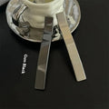 Metal duckbill sub-large hair clip in silver with electroplated finish on solid background