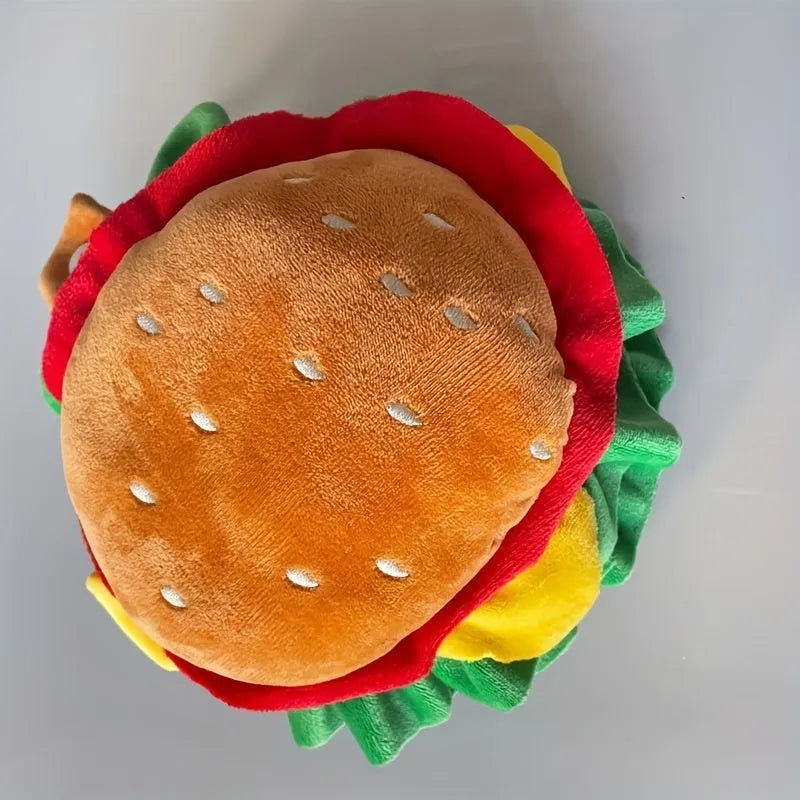 A cat wearing a soft hamburger-shaped headdress collar as an alternative to a plastic cone.