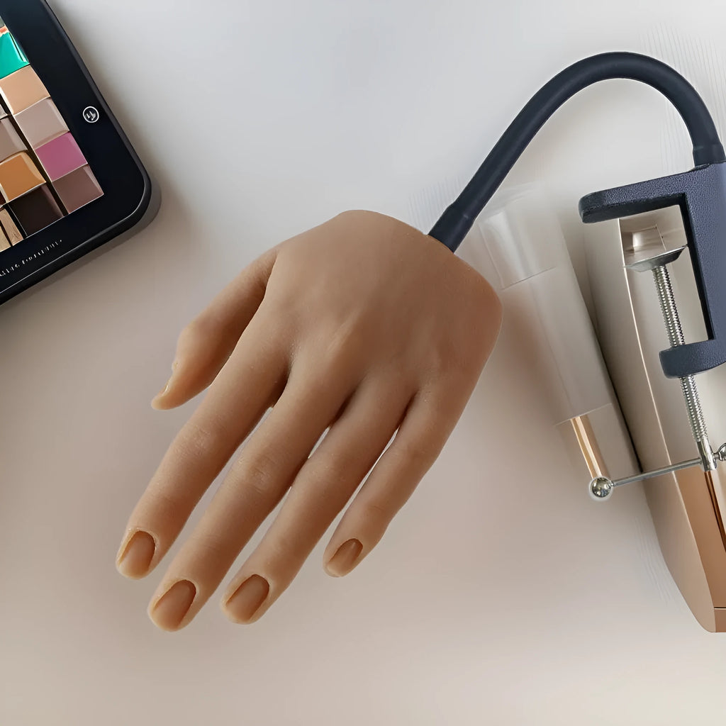 Silicone nail practice hand model with coloured nail tips on fingers for manicurist training.