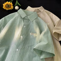 Blue and green striped loose fit plus size half sleeve shirt for women on a hanger