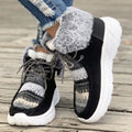 Beige women's lace-up suede snow boots with fuzzy finish and thick rubber sole.
