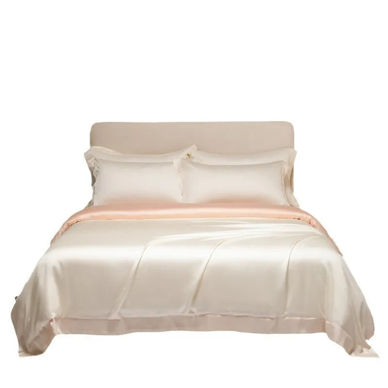Luxury Tencel quilt cover and sheet set in Aurora Blue laid on a bed, showing deep pocket fitted sheet corner.